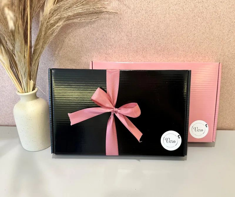 Zwarte en roze cadeaudoos met Vero-labels en roze lint